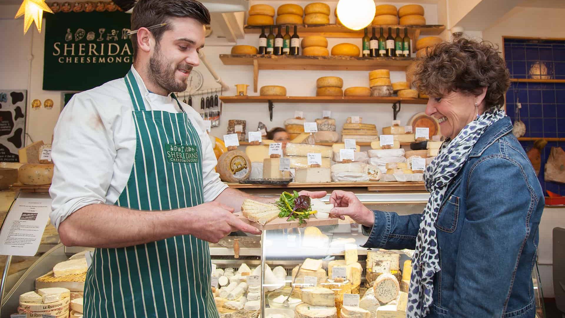 Bay Coast_Galway Market_Cheesemonger Sampling some cheese on the Galway Market Walking Tour